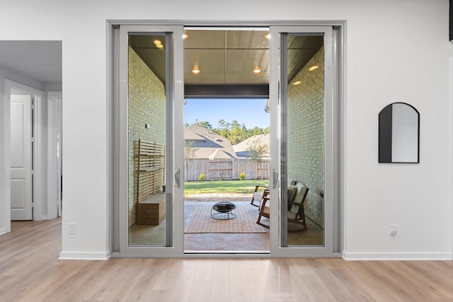 doorway to outside featuring light wood-type flooring