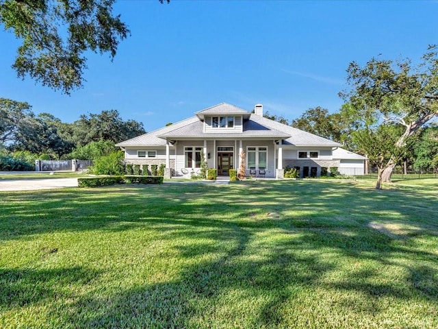 view of front of property with covered porch and a front yard