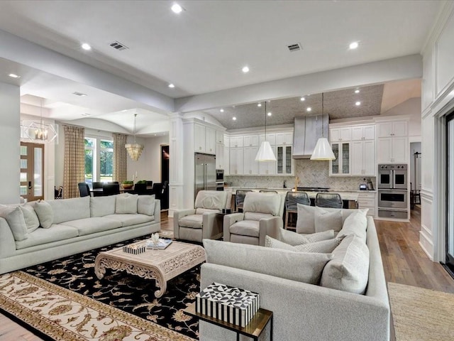 living room featuring light hardwood / wood-style flooring and an inviting chandelier