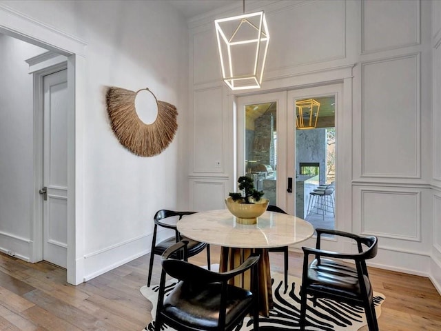 dining room featuring light hardwood / wood-style floors and french doors