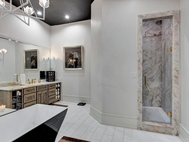 bathroom with plus walk in shower, vanity, tile patterned flooring, and a chandelier