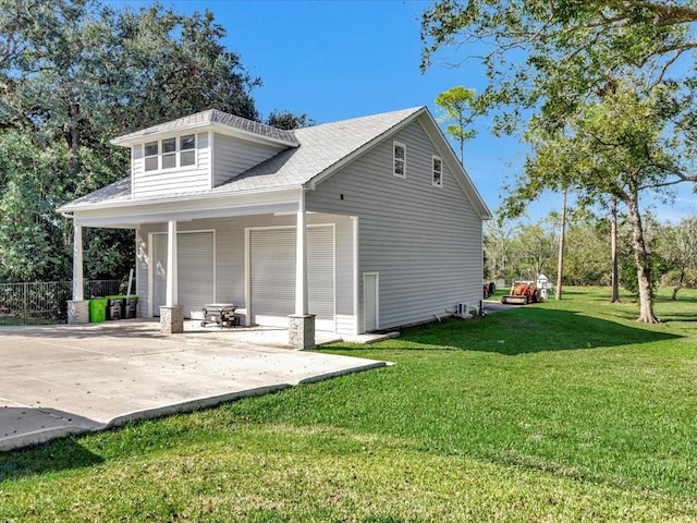 rear view of property featuring a lawn