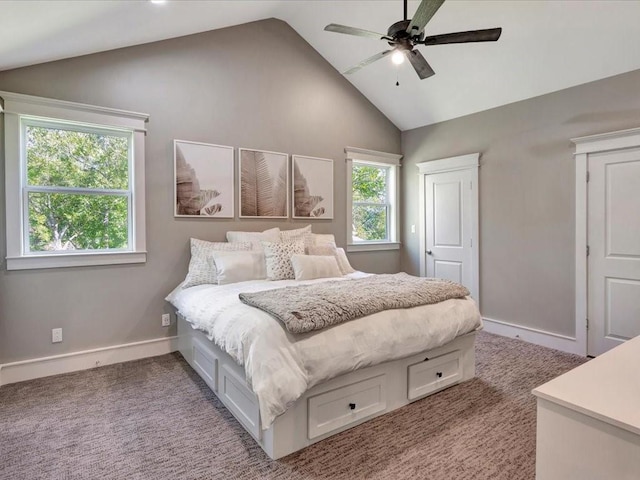 carpeted bedroom with multiple windows, ceiling fan, and high vaulted ceiling