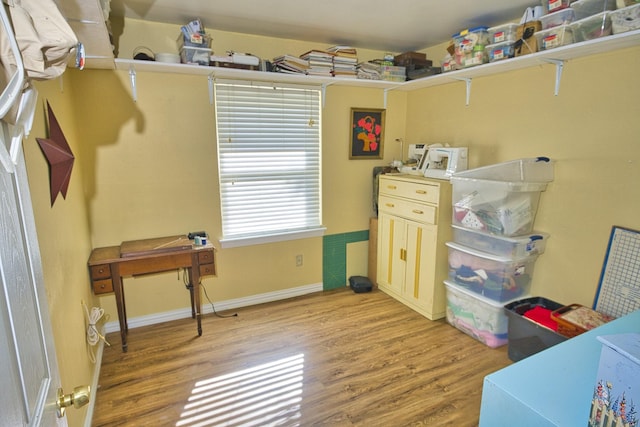 clothes washing area featuring light wood-type flooring