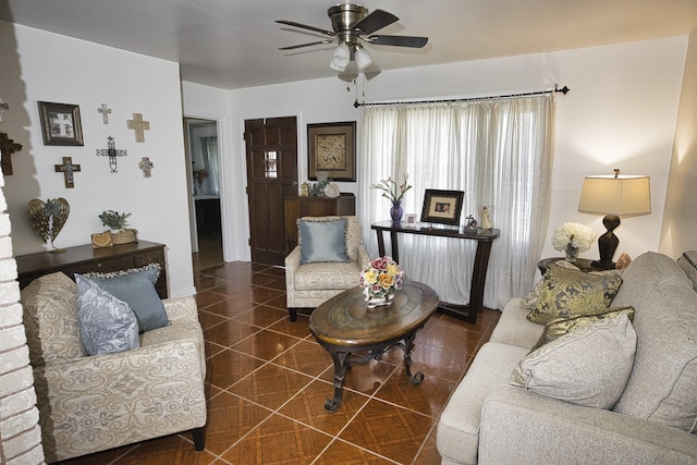 living room with dark tile patterned flooring and ceiling fan