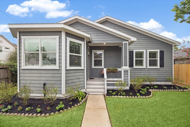 bungalow with a front lawn and a porch