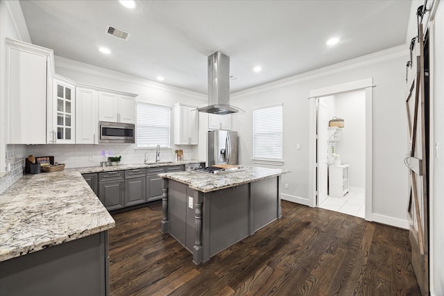 kitchen featuring island range hood, white cabinets, a kitchen island, dark hardwood / wood-style flooring, and stainless steel appliances