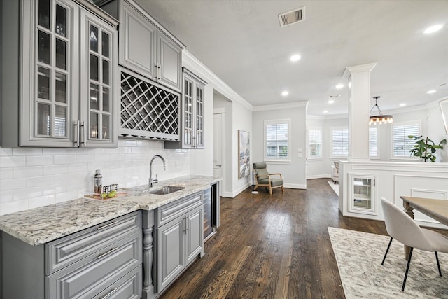 kitchen with gray cabinetry, decorative backsplash, dark hardwood / wood-style flooring, and sink