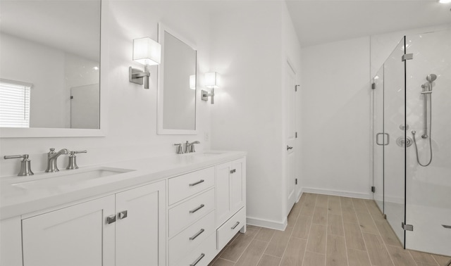 bathroom with an enclosed shower, vanity, and wood-type flooring