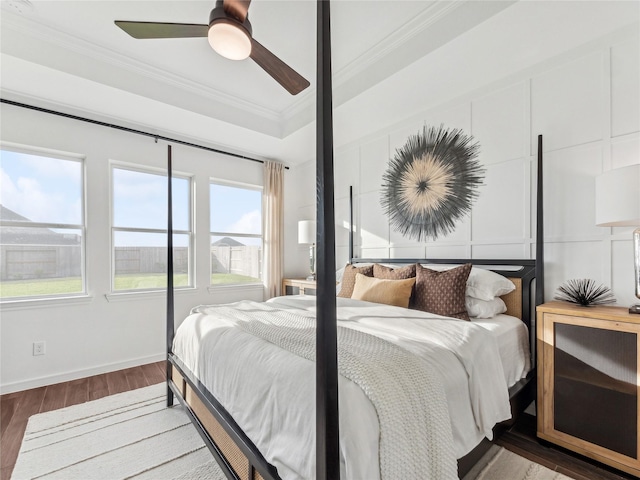 bedroom featuring ornamental molding, hardwood / wood-style floors, and ceiling fan