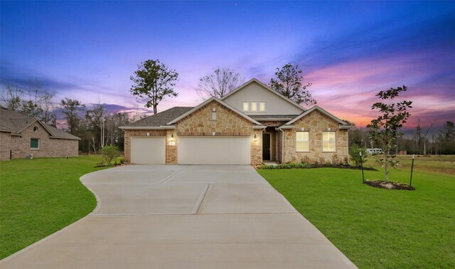 view of front of house with a yard and a garage