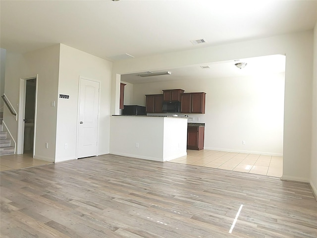 unfurnished living room featuring light hardwood / wood-style floors