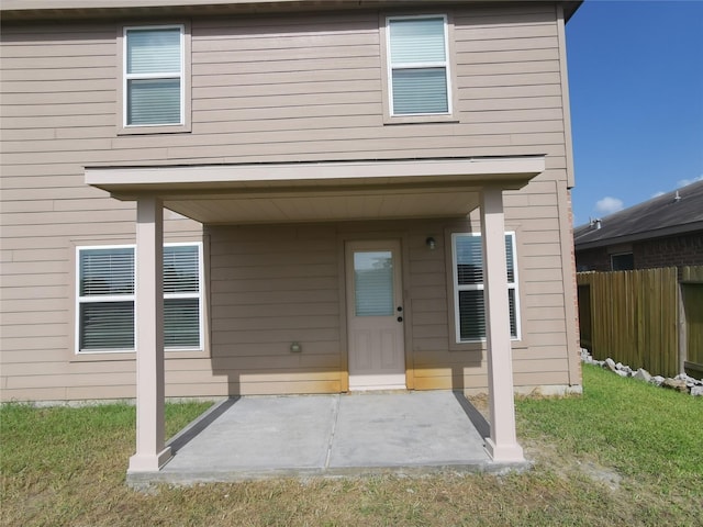 rear view of house featuring a yard and a patio area