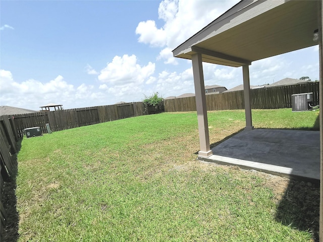 view of yard with central air condition unit and a patio