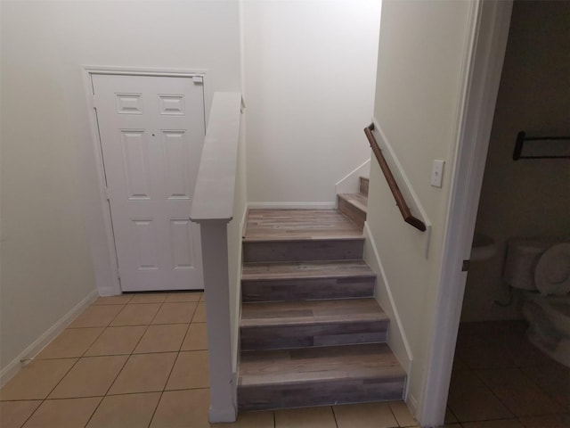 stairs featuring wood-type flooring