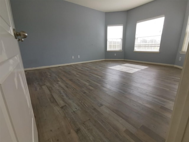 spare room with dark wood-type flooring