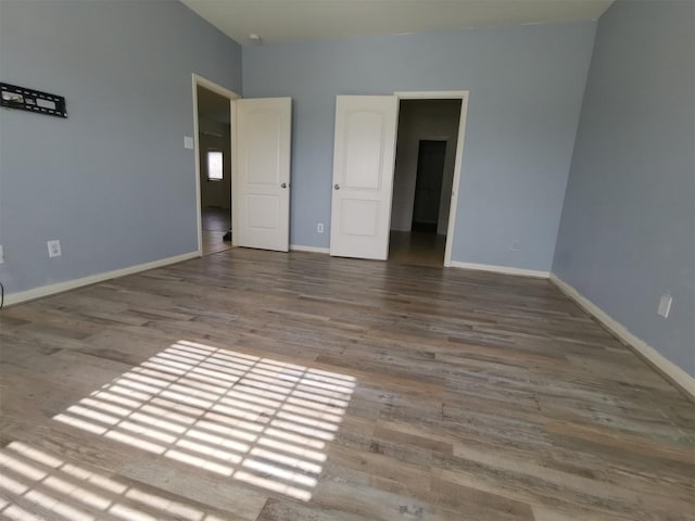 unfurnished bedroom with hardwood / wood-style flooring