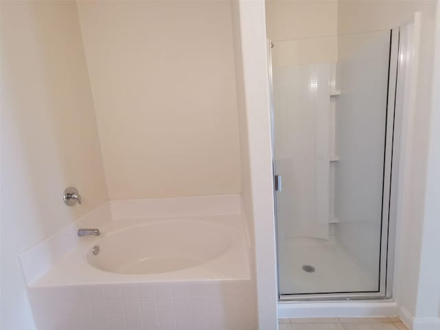 bathroom featuring tile patterned flooring and shower with separate bathtub