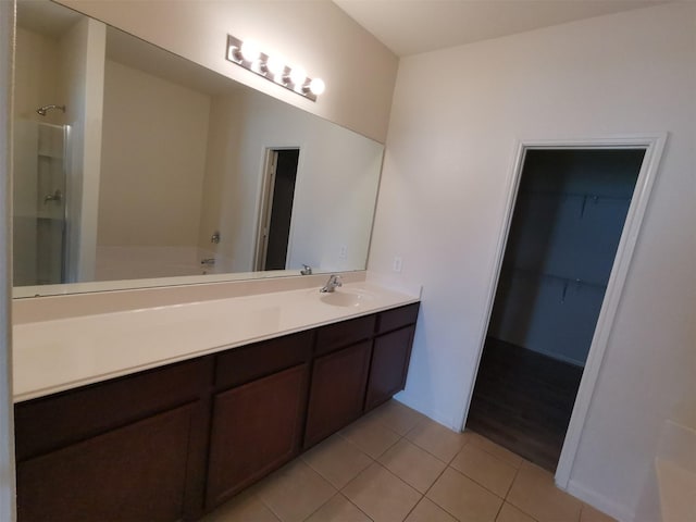 bathroom featuring vanity, tile patterned floors, and separate shower and tub