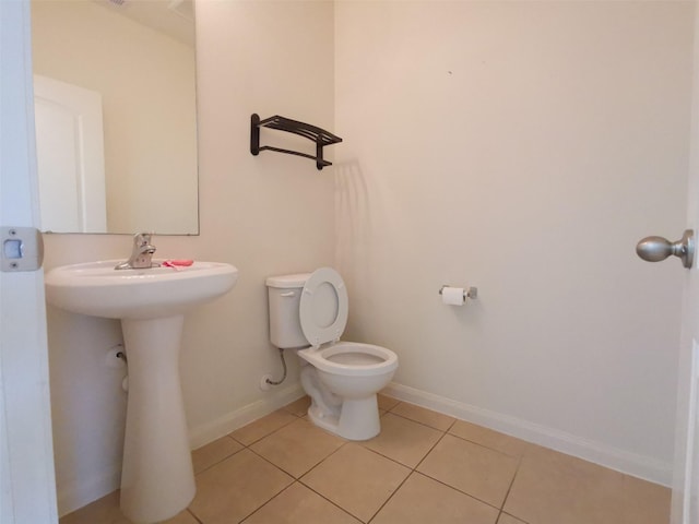 bathroom featuring tile patterned flooring and toilet