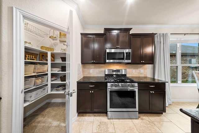 kitchen featuring plenty of natural light, ornamental molding, backsplash, and appliances with stainless steel finishes