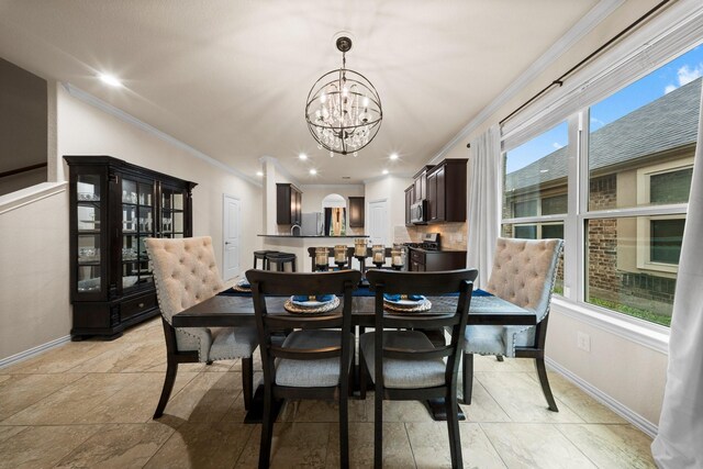 dining room featuring a wealth of natural light, an inviting chandelier, and ornamental molding