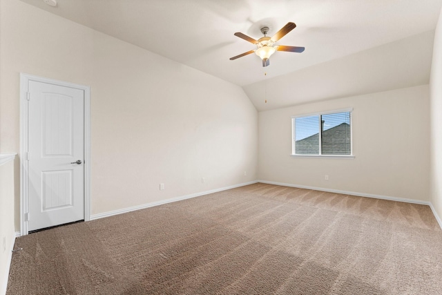 carpeted spare room with ceiling fan and lofted ceiling