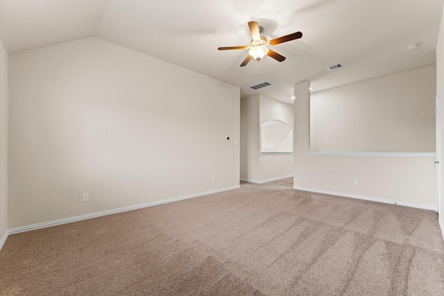 carpeted spare room featuring ceiling fan and vaulted ceiling