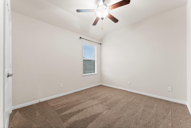 spare room featuring ceiling fan, carpet floors, and vaulted ceiling