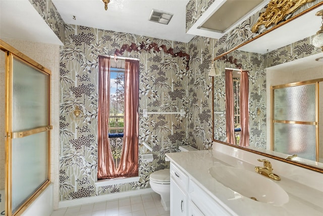 bathroom with tile patterned flooring, vanity, and toilet