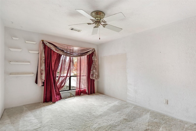 unfurnished room with carpet, a textured ceiling, and ceiling fan