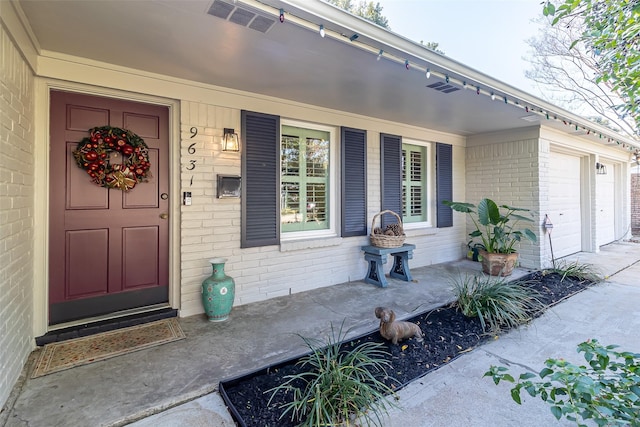 property entrance featuring a porch and a garage