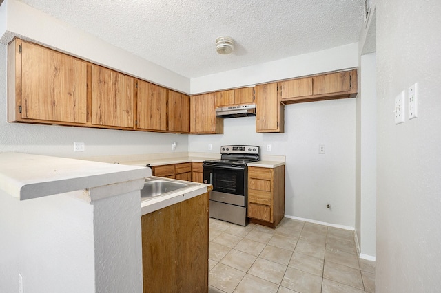 kitchen featuring a textured ceiling, stainless steel range with electric cooktop, and light tile patterned floors