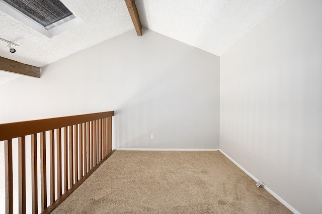 additional living space featuring a textured ceiling, carpet floors, and lofted ceiling with beams