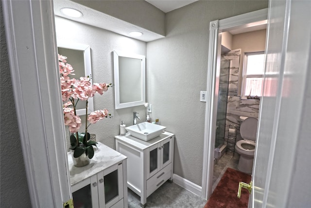 bathroom featuring vanity, toilet, and a shower with shower door