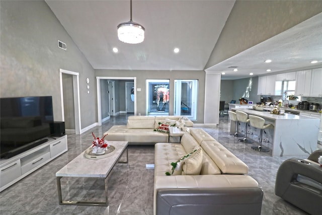 living room with high vaulted ceiling