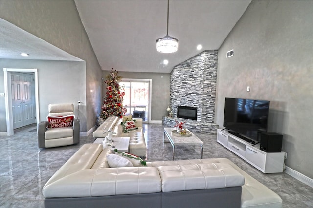 living room with high vaulted ceiling and a stone fireplace