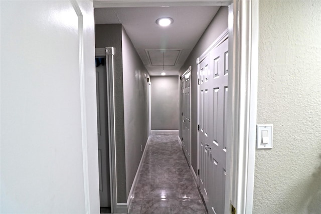 hall featuring dark tile patterned flooring