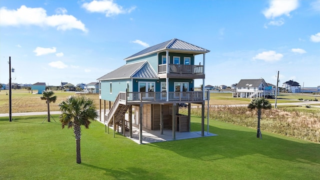 4003 Mitote Dr, Galveston, TX 77554 - back of house featuring a patio area, a lawn, stairs, a deck, and metal roof