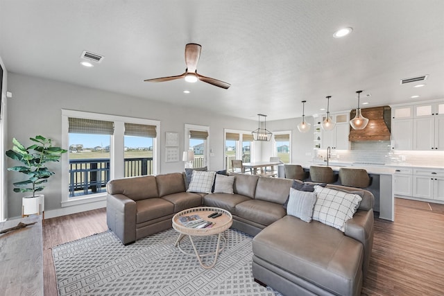 4003 Mitote Dr, Galveston, TX 77554 - living room featuring plenty of natural light, wood finished floors, ceiling fan, and recessed lighting