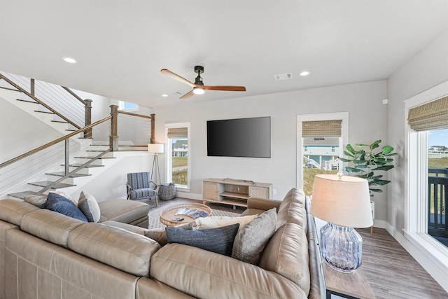 living room featuring hardwood / wood-style flooring and ceiling fan