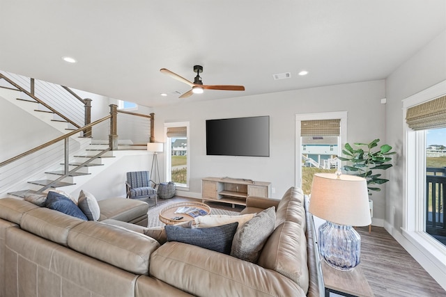 4003 Mitote Dr, Galveston, TX 77554 - living room featuring wood finished floors, stairs, a ceiling fan, recessed lighting, and baseboards