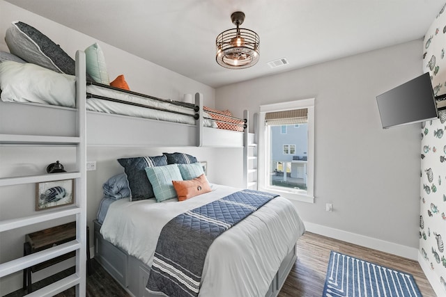 bedroom with dark hardwood / wood-style flooring