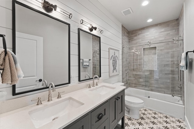 4003 Mitote Dr, Galveston, TX 77554 - bathroom featuring toilet, bath / shower combo with glass door, double vanity, recessed lighting, and tile patterned floors