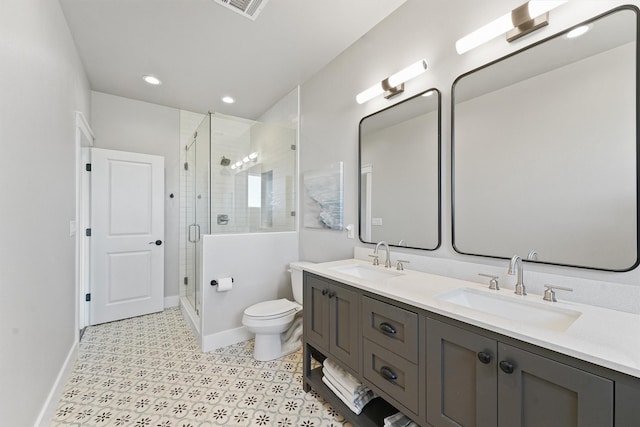 bathroom featuring vanity, an enclosed shower, and toilet