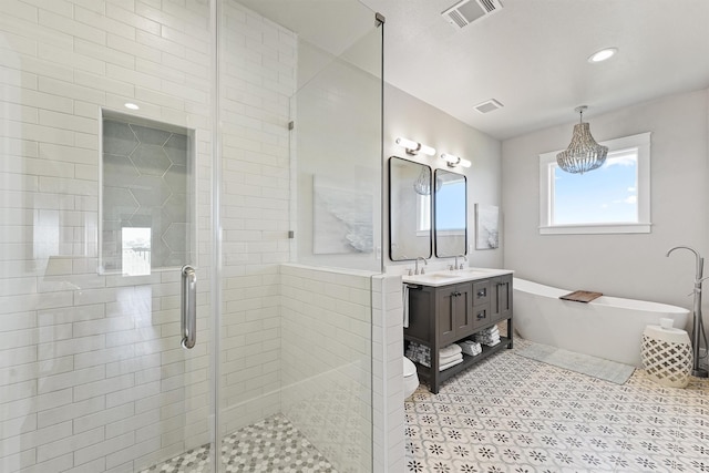 bathroom with vanity and separate shower and tub