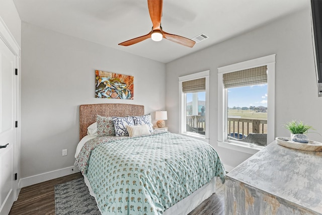 bedroom with ceiling fan and dark hardwood / wood-style floors