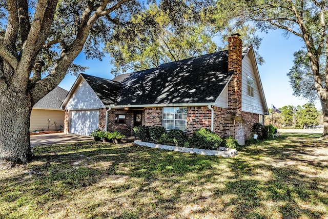 view of front of home with a front yard and a garage