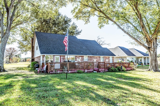 rear view of property with a deck and a lawn