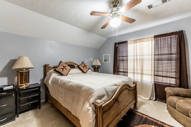 carpeted bedroom with a textured ceiling, ceiling fan, and lofted ceiling